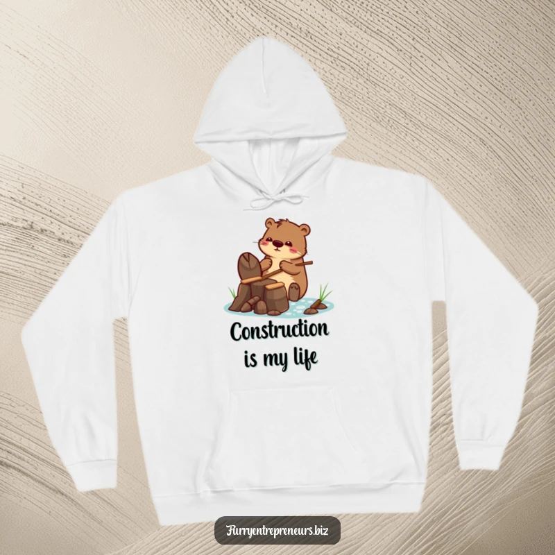 Funny hoodie with a beaver character building a tiny dam with tiny sticks, exuding warmth and industrious charm.